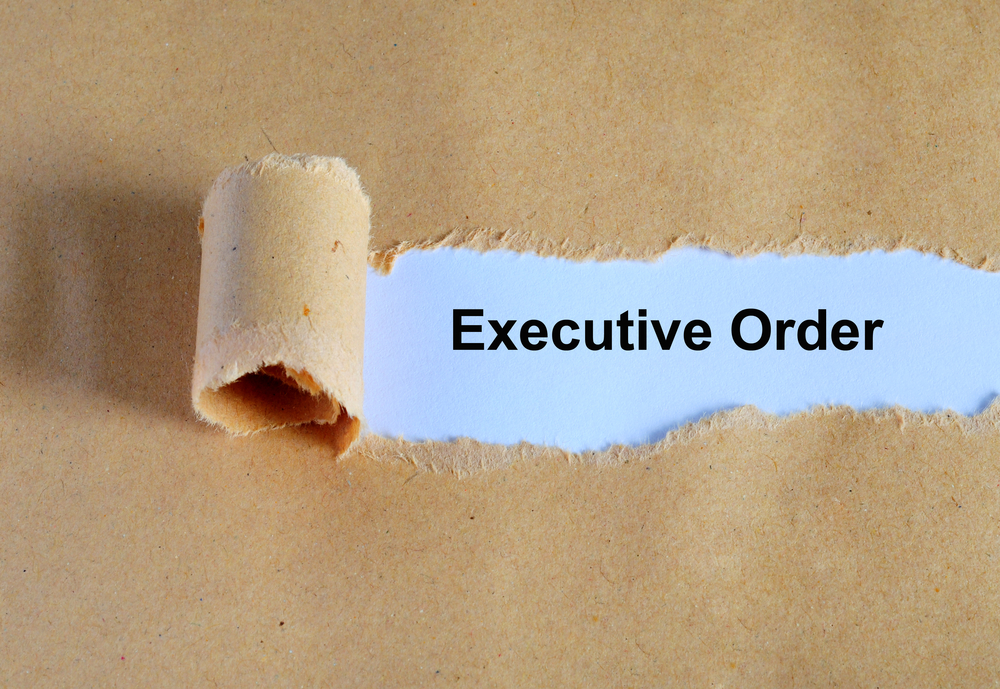 Image of butcher paper, with a portion peeled back, showing "Executive Order" on a blue background.