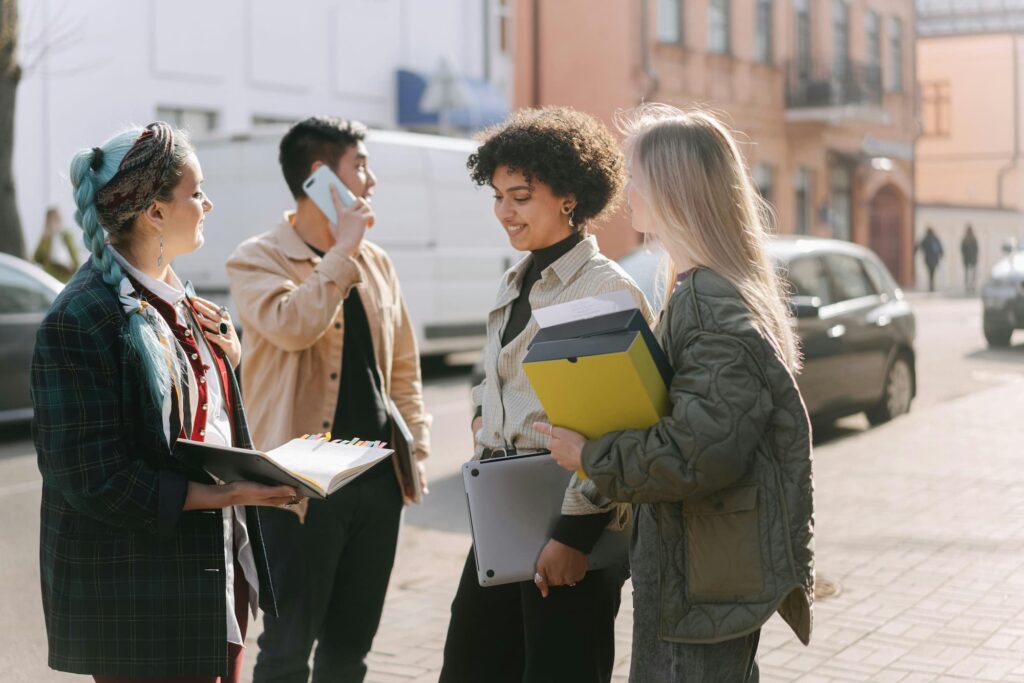 Diverse professionals standing together outdoors, promoting workplace inclusion.
