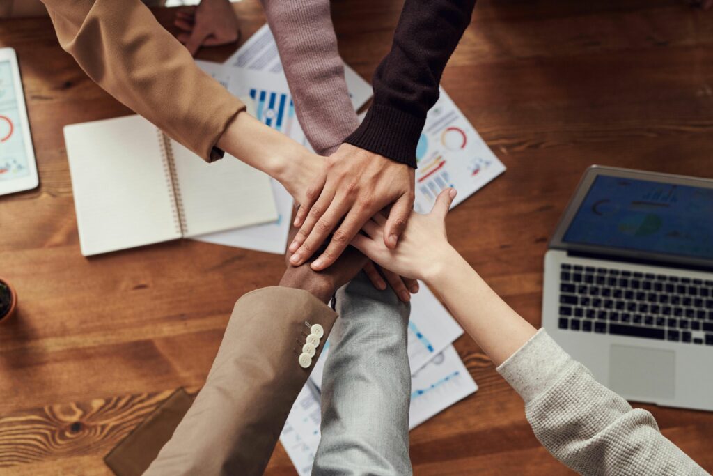 A group of engaged employees actively participating in a lively team meeting in a bright modern office, symbolizing the enthusiasm and collaboration essential for boosting employee engagement in 2025.