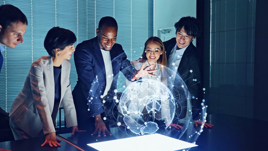 A group of five people looking at a hologram of a globe and connectes dots